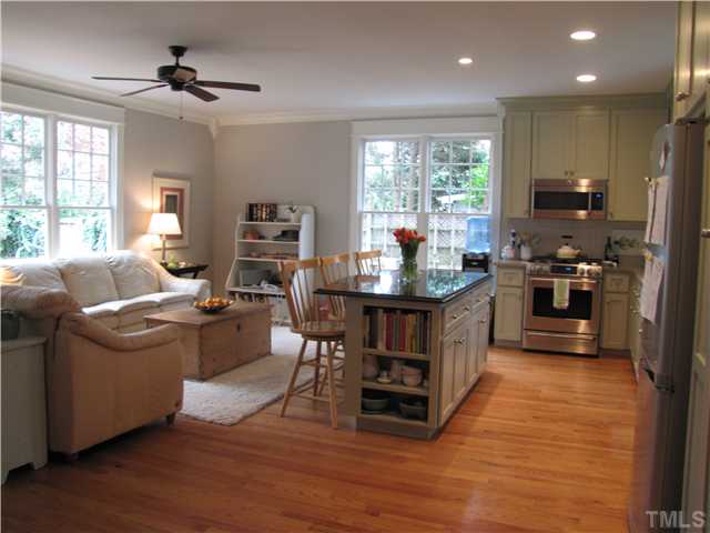 2205 The Circle Raleigh, NC 27608 - Photo 2 of 5 a living room with furniture a fireplace and a flat screen tv