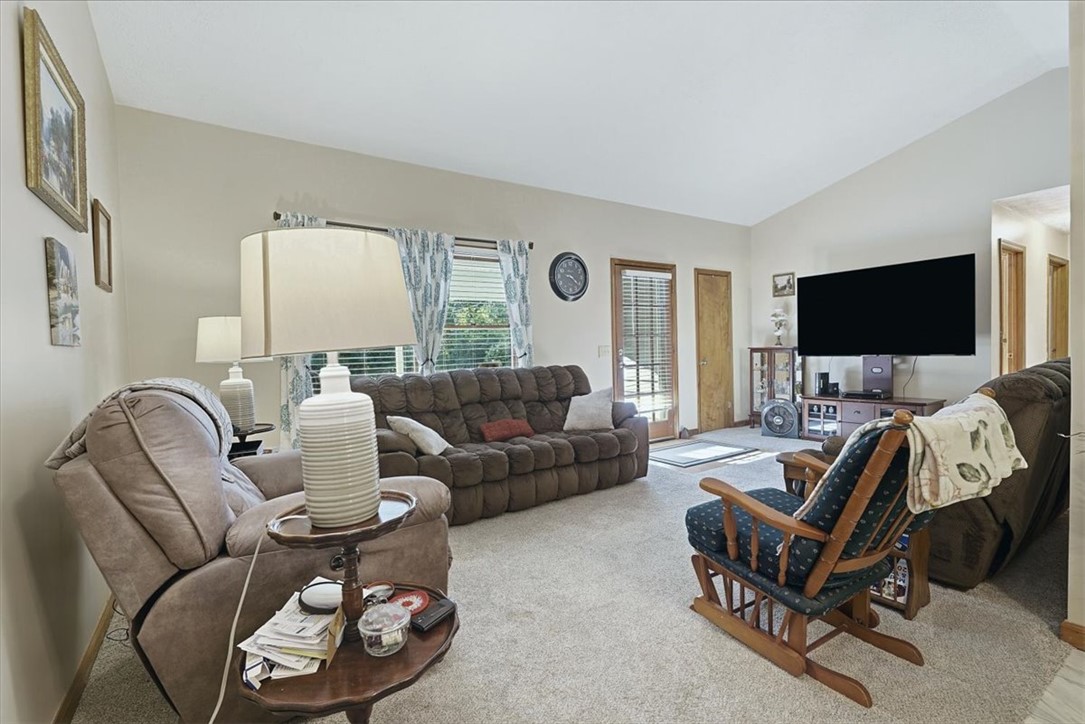 211 Cedar Ridge Drive Westminster, SC 29693 - Photo 6 of 34 A vaulted ceiling rises above this comfortable gathering space featuring soft carpeted flooring.