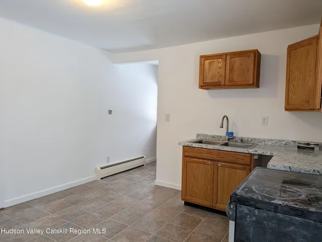 a kitchen that has a sink and a stove