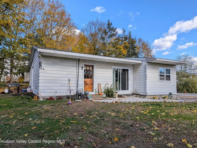 a backyard of a house with outdoor seating