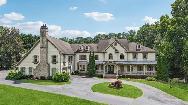 a front view of a house with a garden and plants
