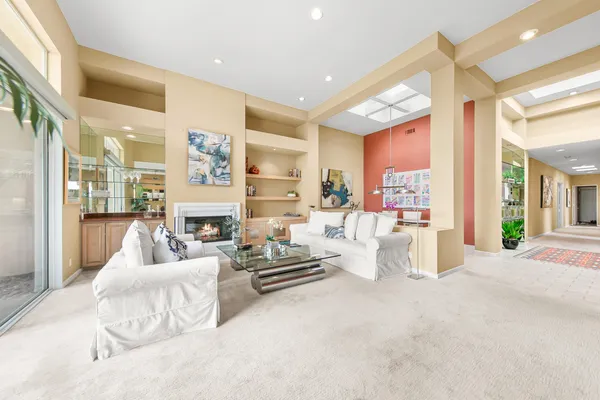 a bedroom with furniture and large windows