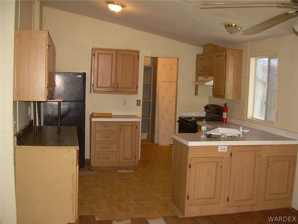 3644 Eloy Road Golden Valley, AZ 86413 - Photo 35 of 35 a kitchen view with cabinets and refrigerator
