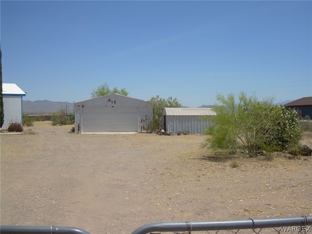3644 Eloy Road Golden Valley, AZ 86413 - Photo 4 of 35 a view of a dry yard with a house