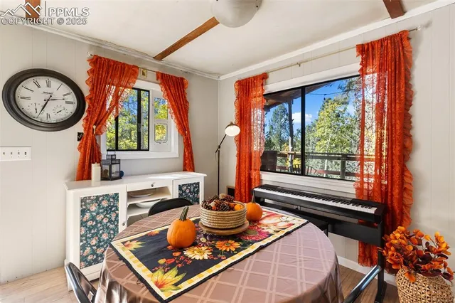 a living room with furniture a large window and a fireplace