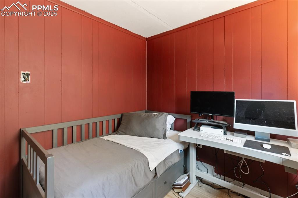 679 Calcite Drive Divide, CO 80814 - Photo 24 of 35 a bedroom with a bed and a flat screen tv
