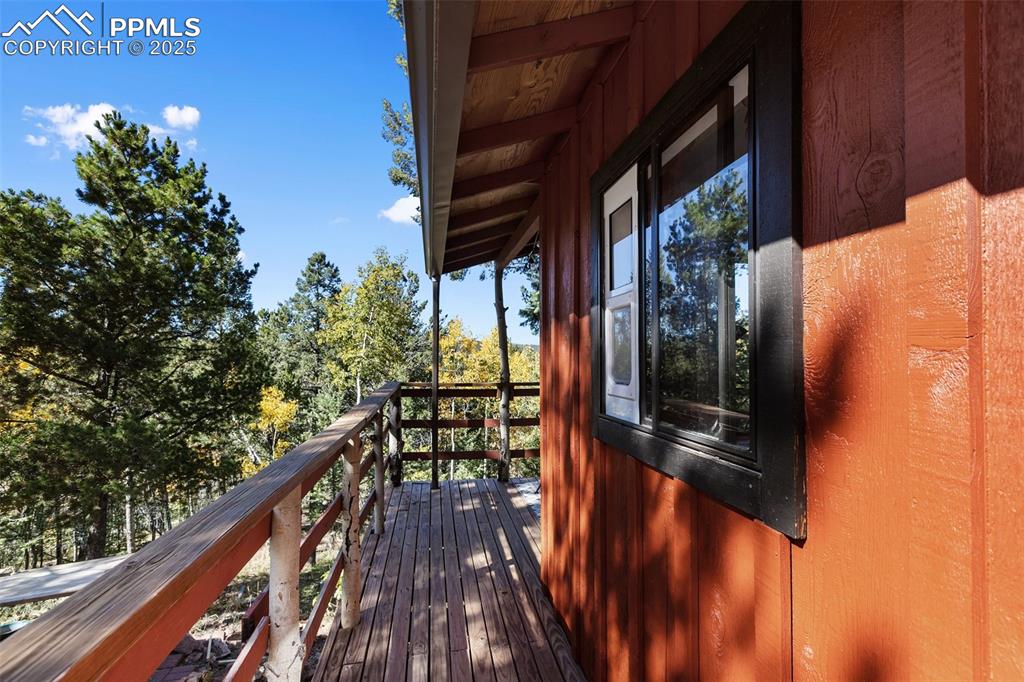 679 Calcite Drive Divide, CO 80814 - Photo 3 of 35 a balcony with wooden floor and outdoor seating