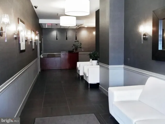 a bathroom with a sink a mirror and a glass door