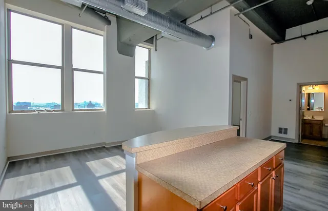 a view of a kitchen that has a sink and a window