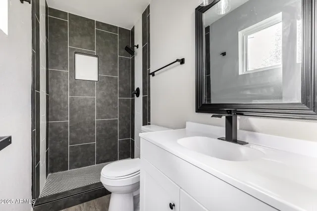 a bathroom with a sink toilet and shower