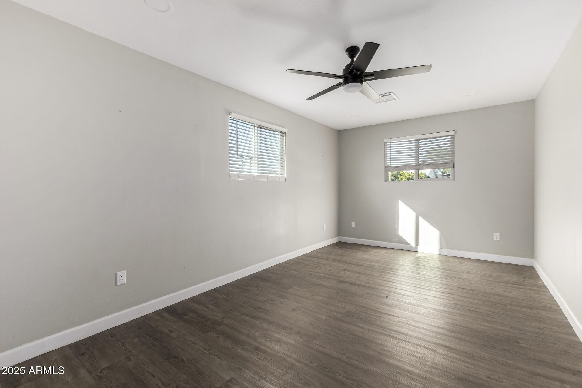 331 East Pierce Street Tempe, AZ 85288 - Photo 19 of 37 an empty room with wooden floor ceiling fan and windows