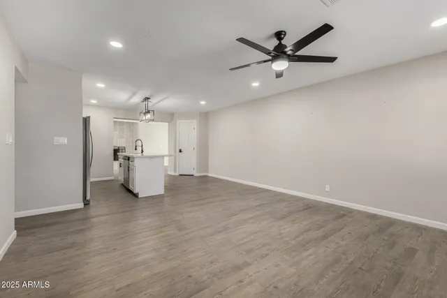 a view of an empty room with a kitchen