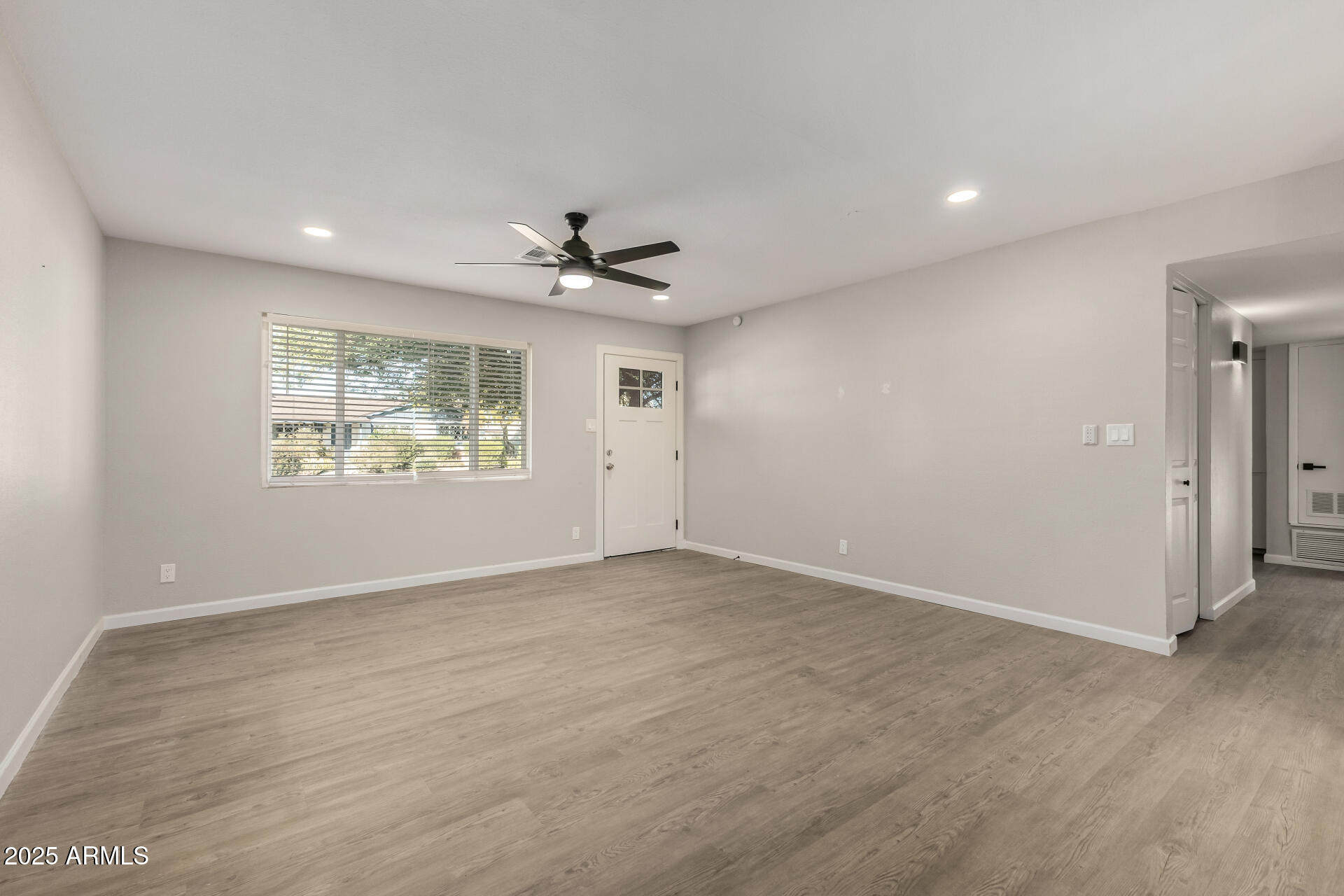 331 East Pierce Street Tempe, AZ 85288 - Photo 5 of 37 an empty room with windows and ceiling fan
