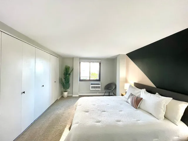 a kitchen with white cabinets and refrigerator