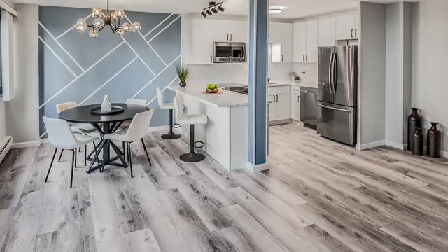 a very nice looking room with a dining table chairs with wooden floor