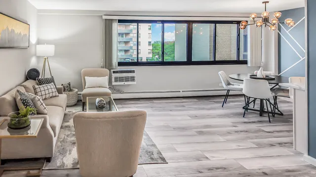 a living room with furniture a window and a table
