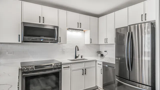 a kitchen with stainless steel appliances a refrigerator stove and sink