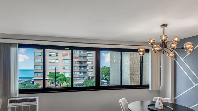 a view of a bedroom with wooden floor and windows