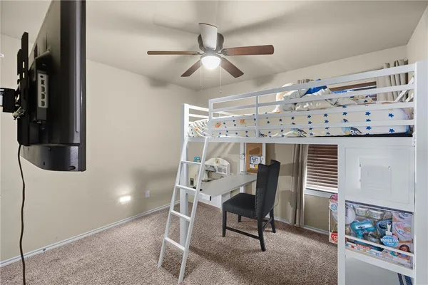 a view of a dining room with furniture and a chandelier fan
