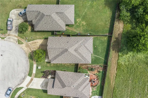 an aerial view of a house with a yard