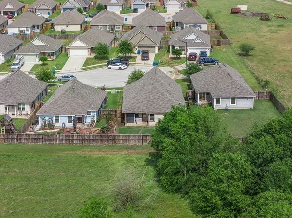 an aerial view of multiple houses with yard