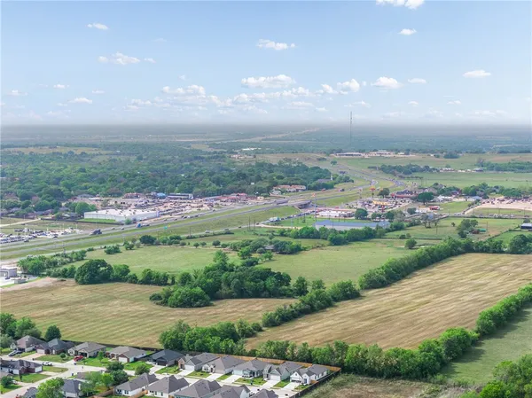 a view of a big yard with an ocean view