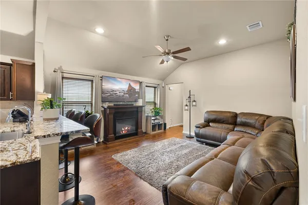 a living room with furniture flat screen tv and a fireplace