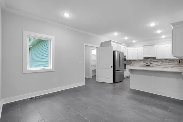 an empty room with an empty space and windows