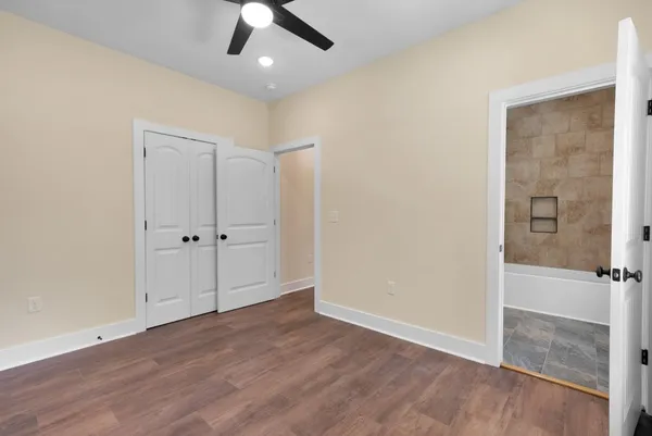 a view of an empty room with wooden floor