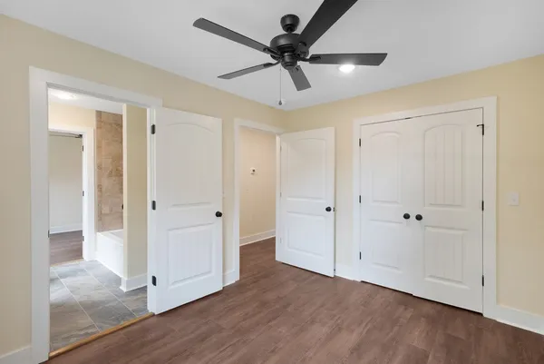 a view of a room with wooden floor and white cabinet
