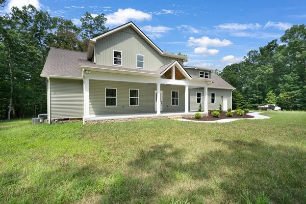 a front view of house with yard and green space