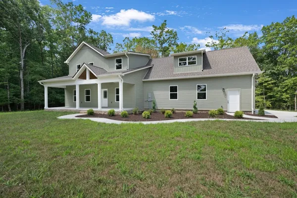 a front view of house with yard and outdoor seating