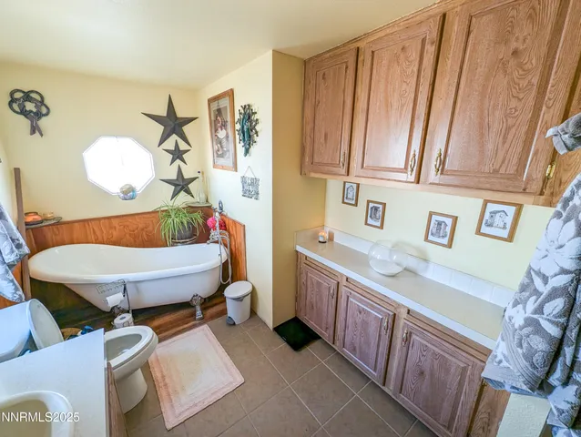 an outdoor sitting area with furniture and barbeque oven