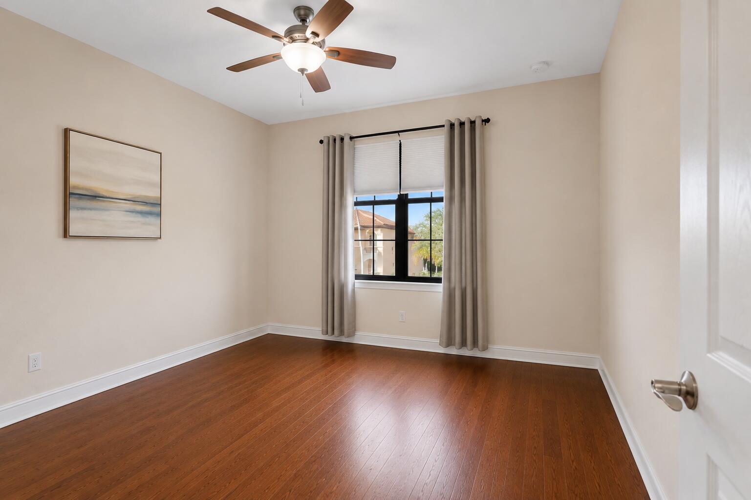 16610 Gateway Bridge Drive Delray Beach, FL 33446 - Photo 18 of 67 a view of an empty room with wooden floor and a window