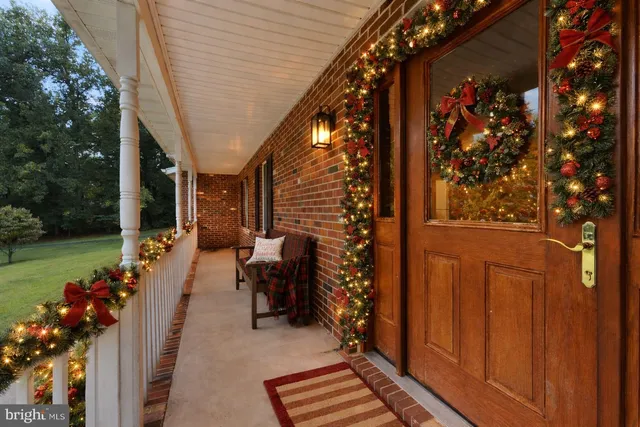 a living room with furniture a chandelier and a fireplace