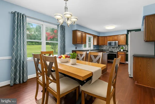 a view of entryway dining room and hall with wooden floor