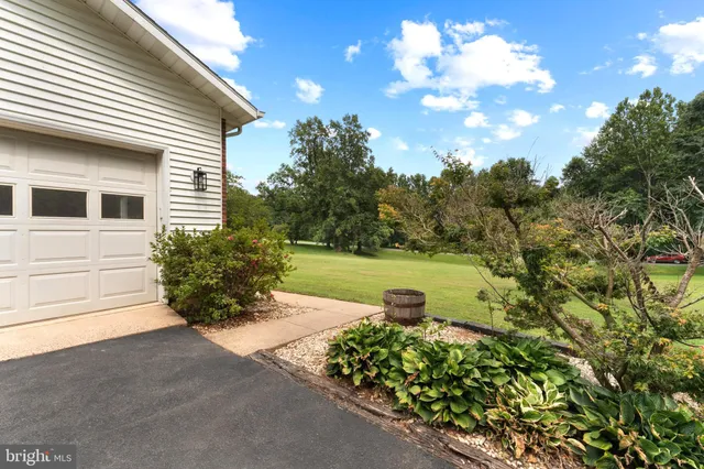 a bathroom with a granite countertop toilet sink and mirror