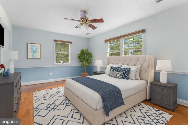 a bedroom with a large bed and a window