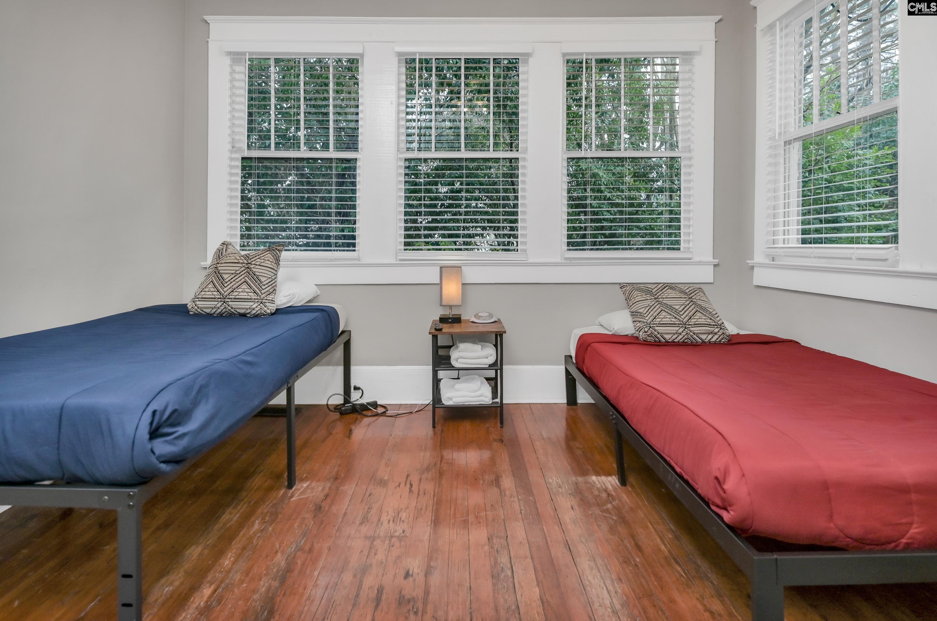 2227 Bull Street Columbia, SC 29201 - Photo 33 of 38 a bedroom with a bed and wooden floor