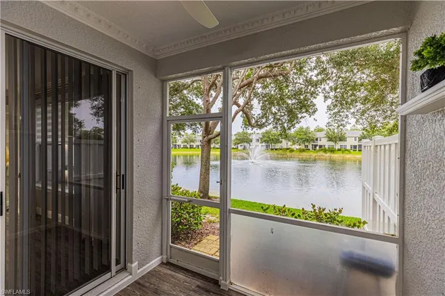an aerial view of lake and residential houses with outdoor space