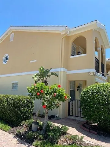 a front view of a house with plants