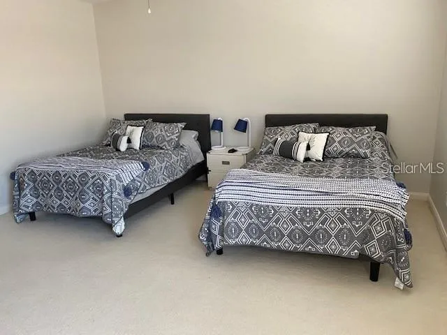 a bedroom with a bed a couch and a night stand