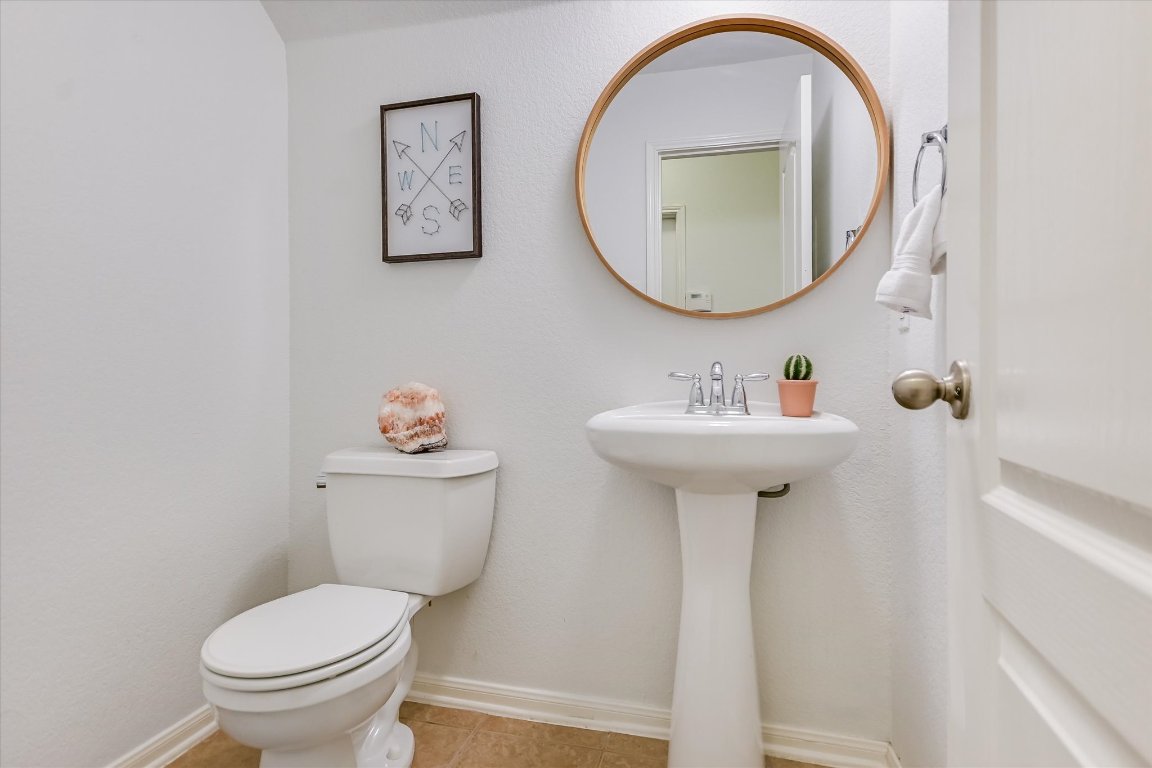 7711 Stephany Taylor Drive Austin, TX 78745 - Photo 11 of 23 a bathroom with a toilet sink and mirror