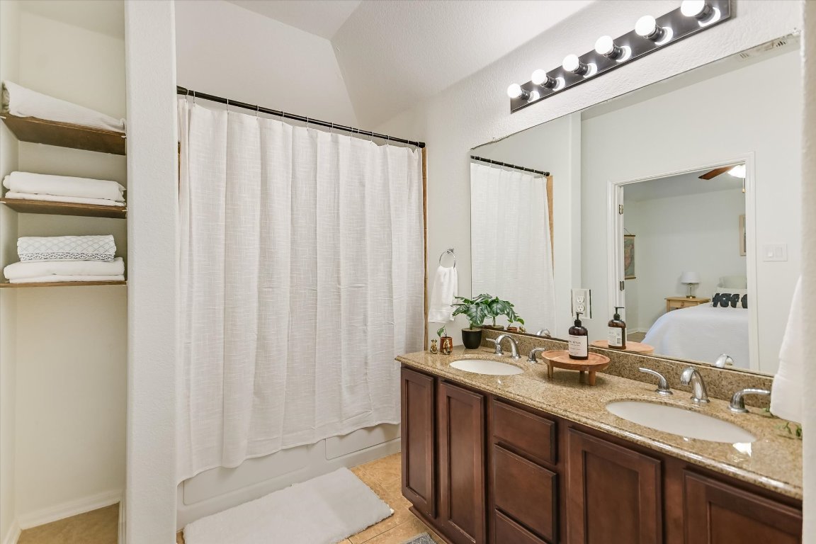 7711 Stephany Taylor Drive Austin, TX 78745 - Photo 13 of 23 a bathroom with a double vanity sink and a mirror