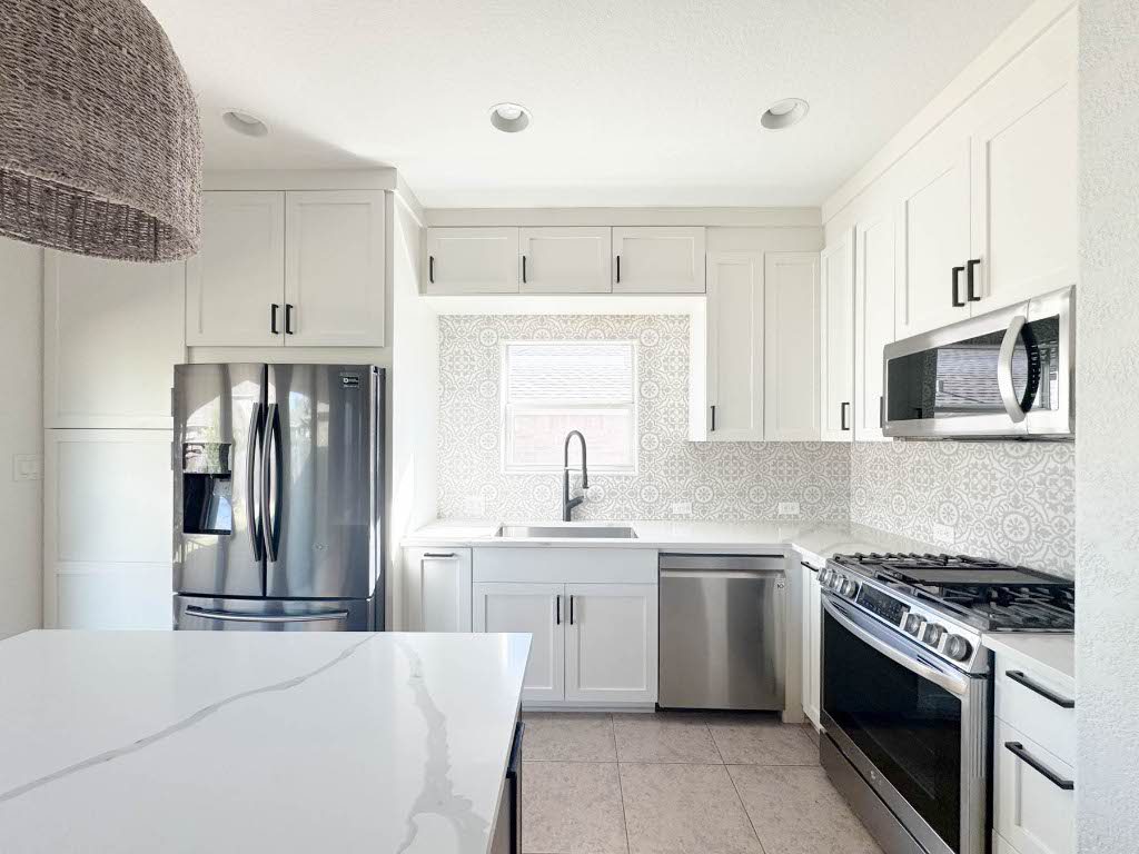7711 Stephany Taylor Drive Austin, TX 78745 - Photo 3 of 23 a kitchen with stainless steel appliances granite countertop a sink stove and refrigerator