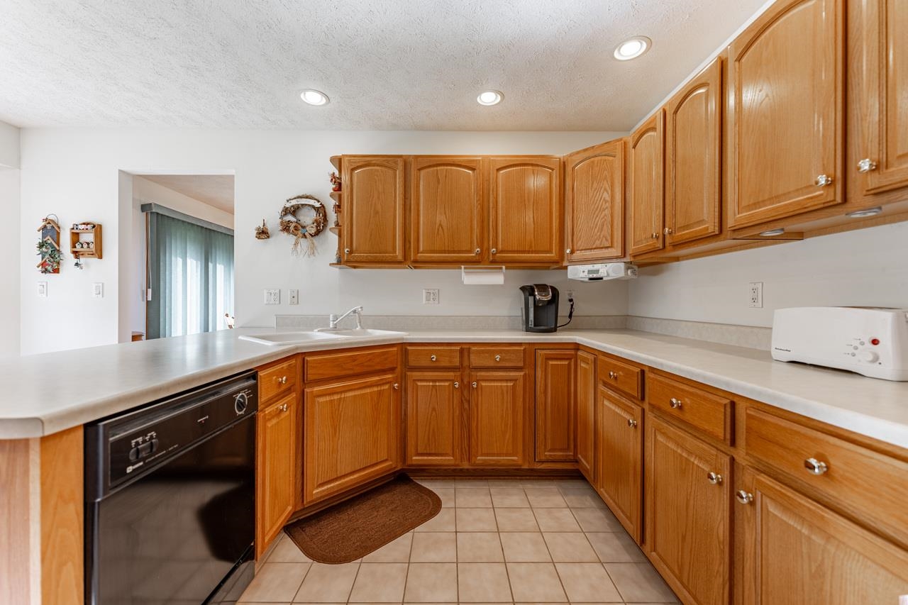 625 Waco Way Poplar Grove, IL 61065 - Photo 11 of 34 a kitchen with stainless steel appliances granite countertop a sink and cabinets