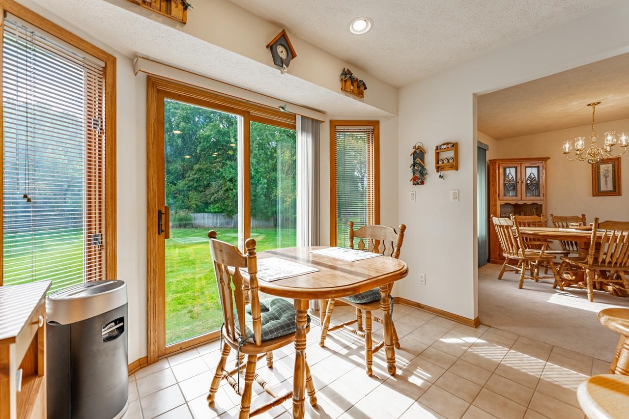 625 Waco Way Poplar Grove, IL 61065 - Photo 13 of 34 a dining room with furniture and a floor to ceiling window