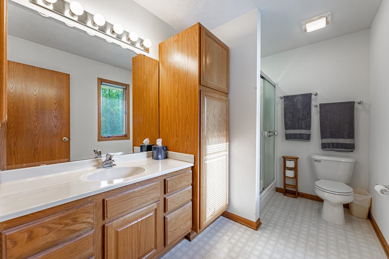 625 Waco Way Poplar Grove, IL 61065 - Photo 17 of 34 a spacious bathroom with a double vanity sink a large mirror and toilet