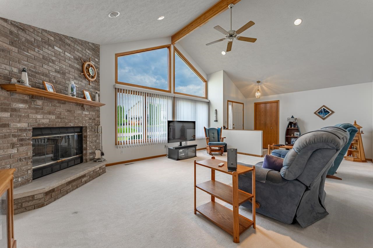 625 Waco Way Poplar Grove, IL 61065 - Photo 7 of 34 a living room with furniture a fireplace and a flat screen tv