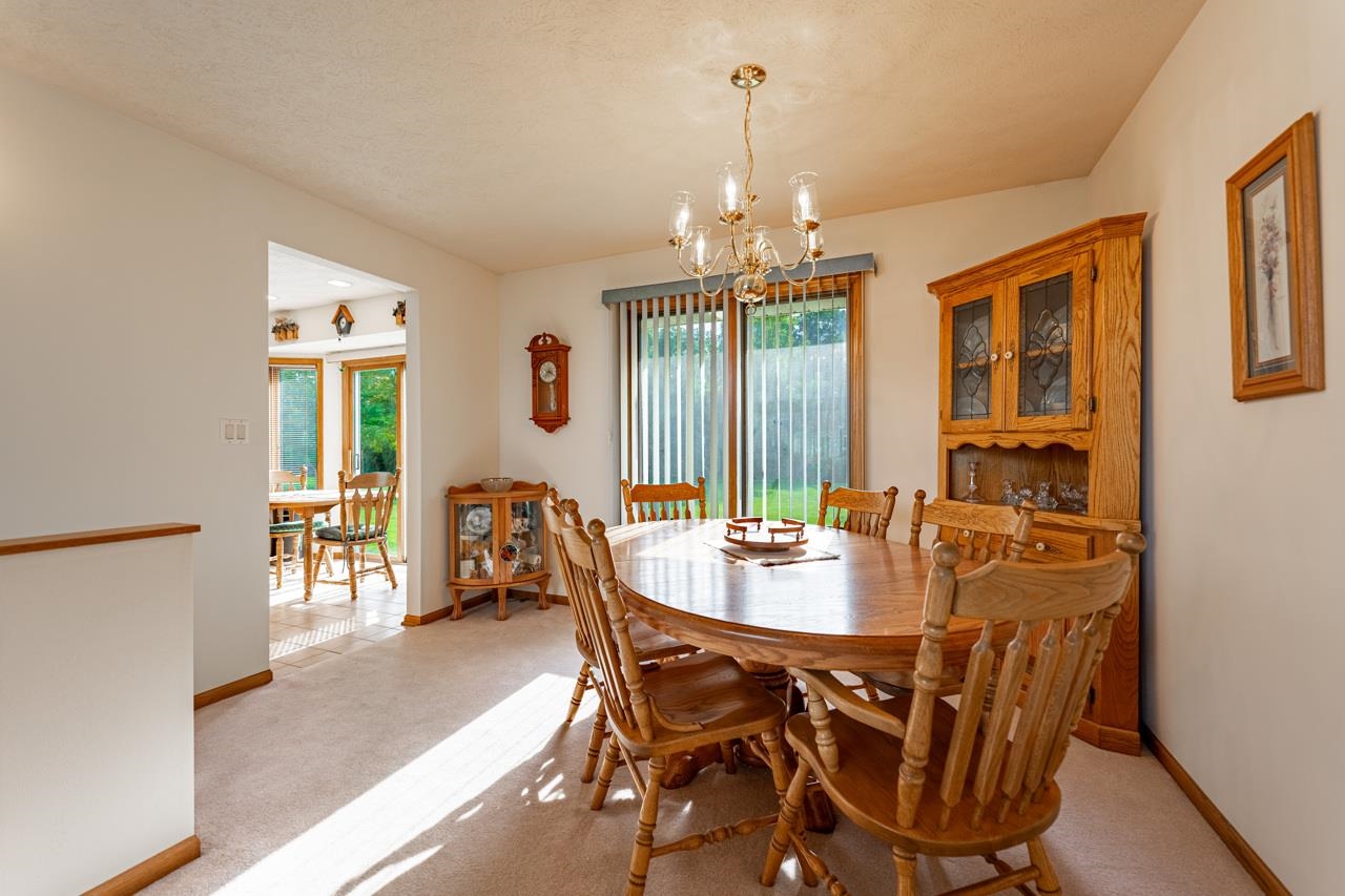 625 Waco Way Poplar Grove, IL 61065 - Photo 9 of 34 a dining room with furniture a chandelier and wooden floor